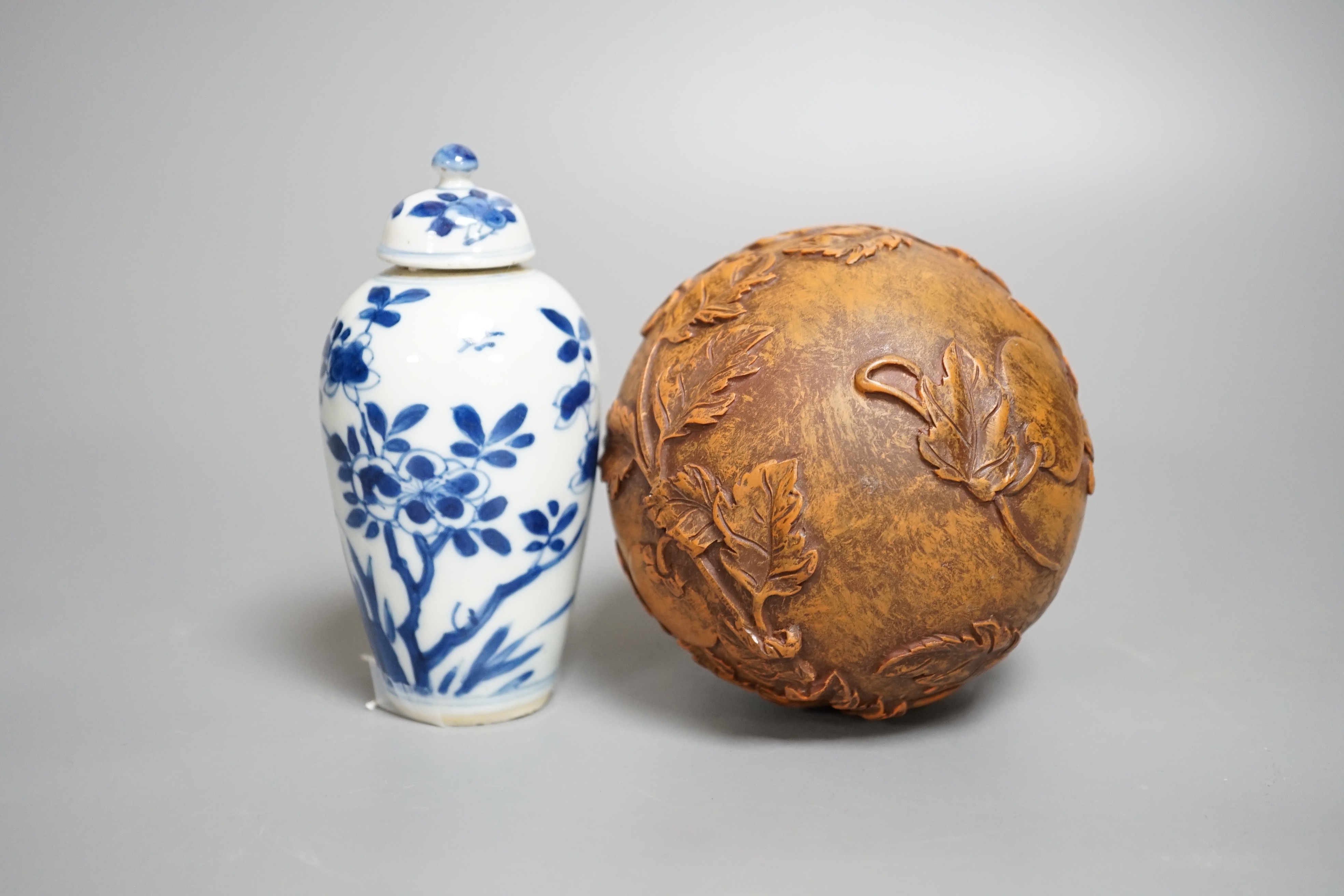 A Chinese blue and white jar and cover, Kangxi period, height 12cm and a Chinese ball